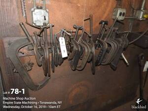 Miscellaneous C-clamps on wall rack