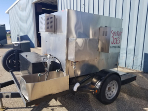 2003 Southern Pride FPK-500-5L trailer mounted 500lb LP fired stainless rotisserie rack smoker with wood box and trailer