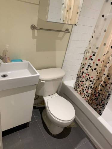 Complete bathroom with sink, toilet, and mirror