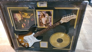AEROSMITH MEMORABILIA FRAME WITH ELECTRIC GUITAR AND "JANIE'S GOT A GUN" GOLD RECORD (SIGNATURES NOT AUTHENTICATED )(43X35)