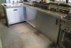 L Shaped S/Steel Work Counter with Sink and Two Sliding Door Undercounter storage, 230cm L x 140cm W x 90cm H. (Located: Cork)