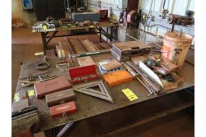 LOT: Contents on Table including Trowels, Squares, Hole Saws, Levels, Grease Zerks (no table or vise)